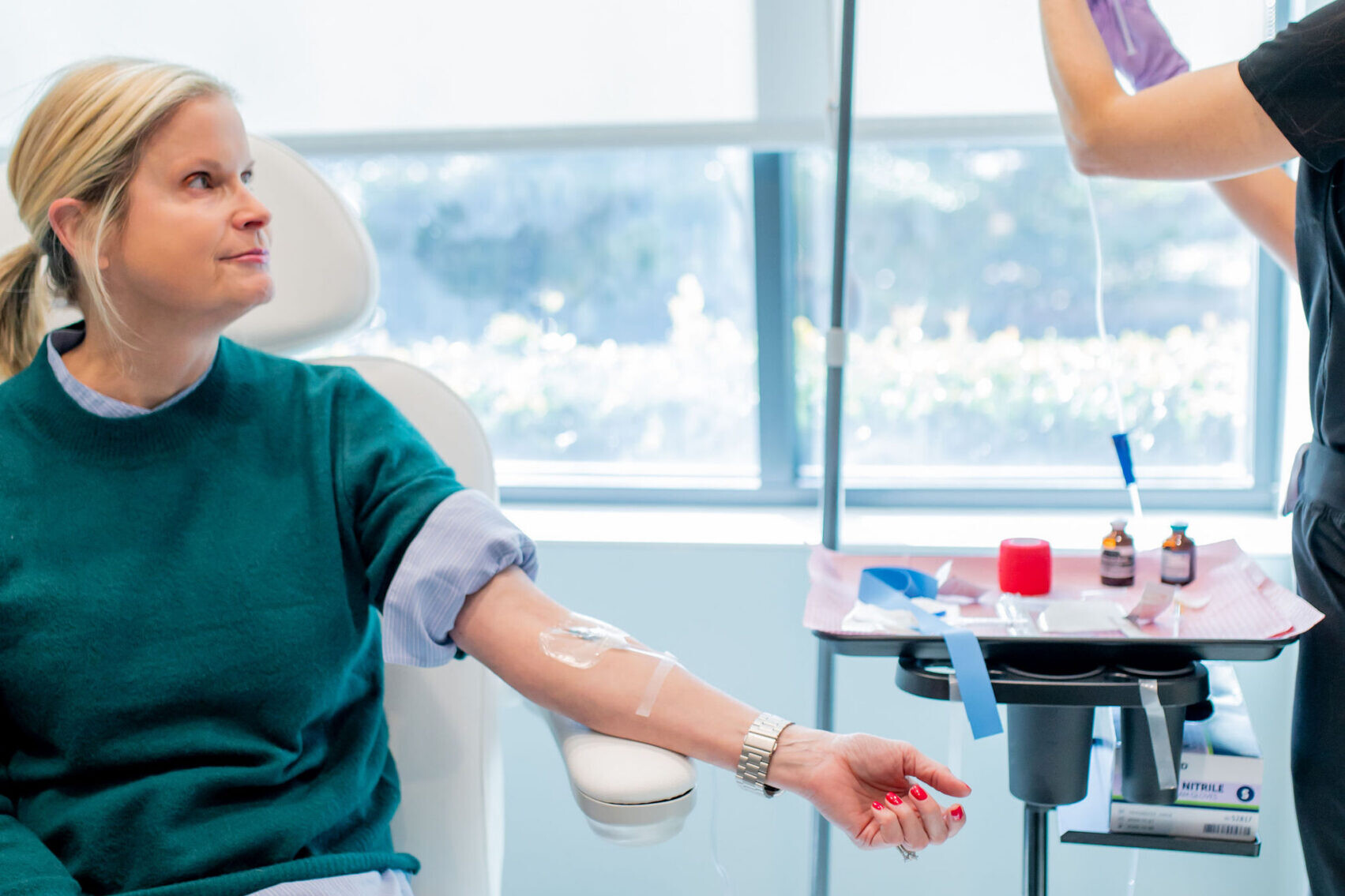 A blonde woman enjoys IV therapy benefits during her advanced hydration treatment at Shine Medical Aesthetics in Alpharetta, GA.