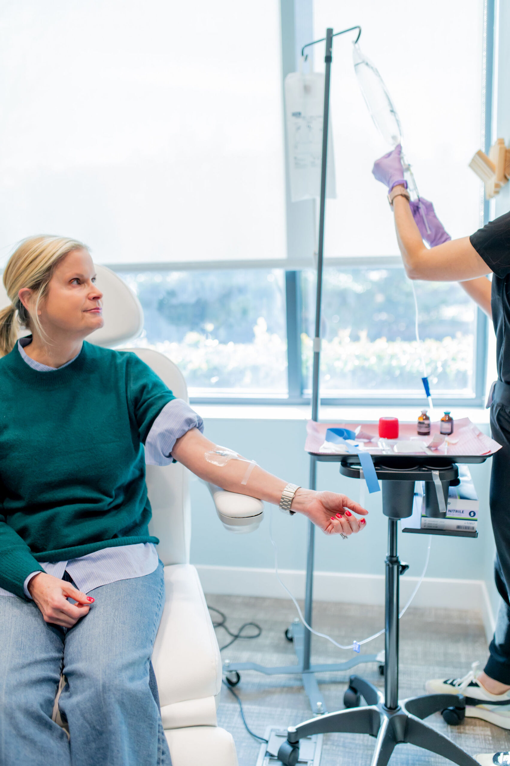 A blonde woman enjoys IV therapy benefits during her advanced hydration treatment at Shine Medical Aesthetics in Alpharetta, GA.