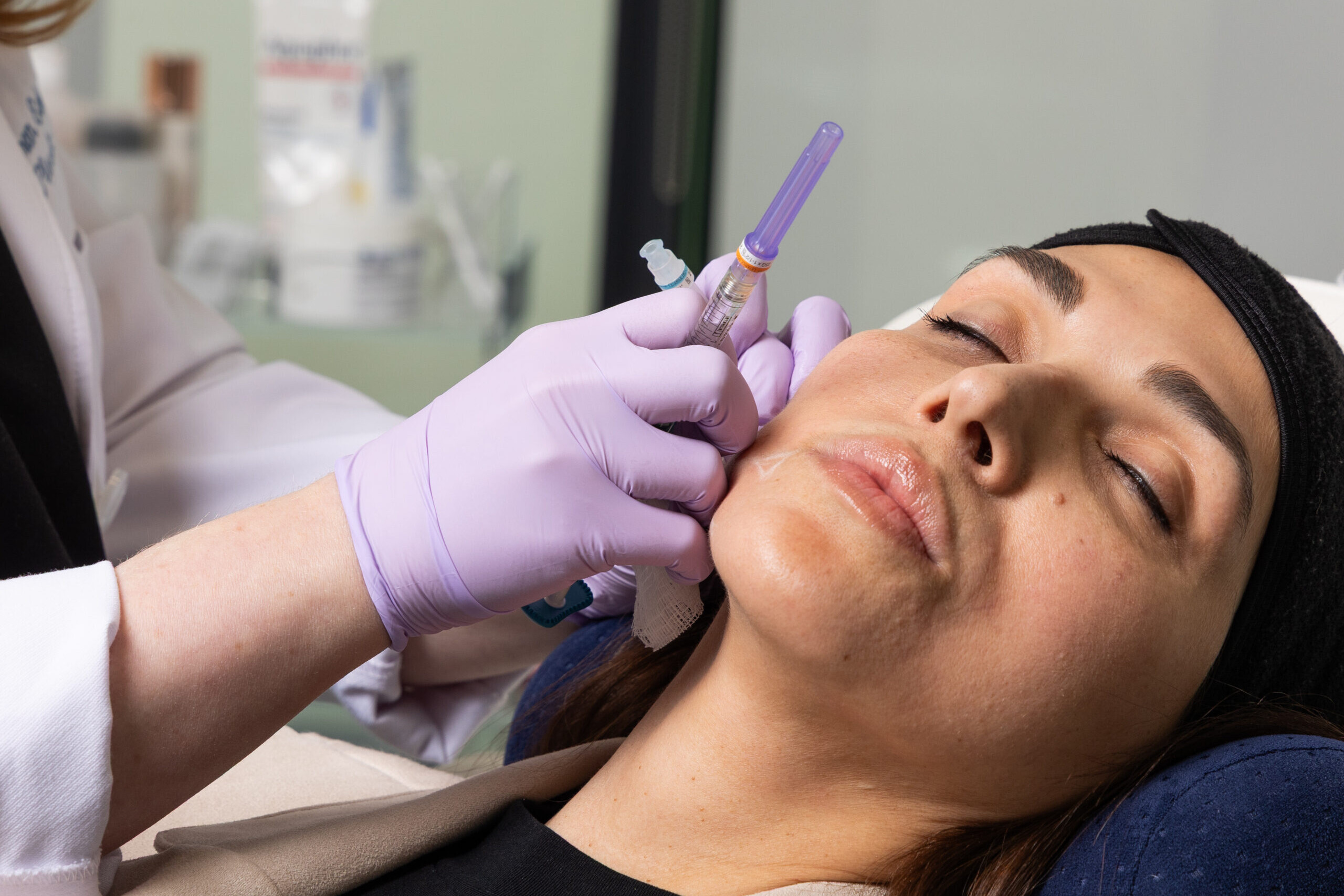 A brunette woman enjoying a Botox treatment in Alpharetta, GA at Shine Medical Aesthetics.